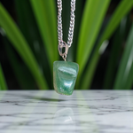 A natural Green Aventurine (African Green Jade) pendant with a polished finish, attached to a metal chain—ideal for men and women’s spiritual wear