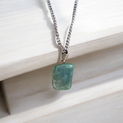 A natural Green Aventurine (African Green Jade) pendant with a polished finish, attached to a metal chain—ideal for men and women’s spiritual wear