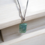 A natural Green Aventurine (African Green Jade) pendant with a polished finish, attached to a metal chain—ideal for men and women’s spiritual wear
