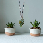 A natural Green Aventurine (African Green Jade) pendant with a polished finish, attached to a metal chain—ideal for men and women’s spiritual wear