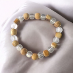 A natural Tulsi and Sphatik crystal bracelet with 8mm beads, handcrafted on stretchable cord, used for meditation and spiritual practice