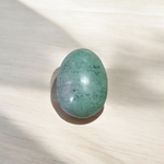 A natural greenish-black Shivling stone, hand-carved and polished, ideal for Tulsi plants, garden altars, and temple worship