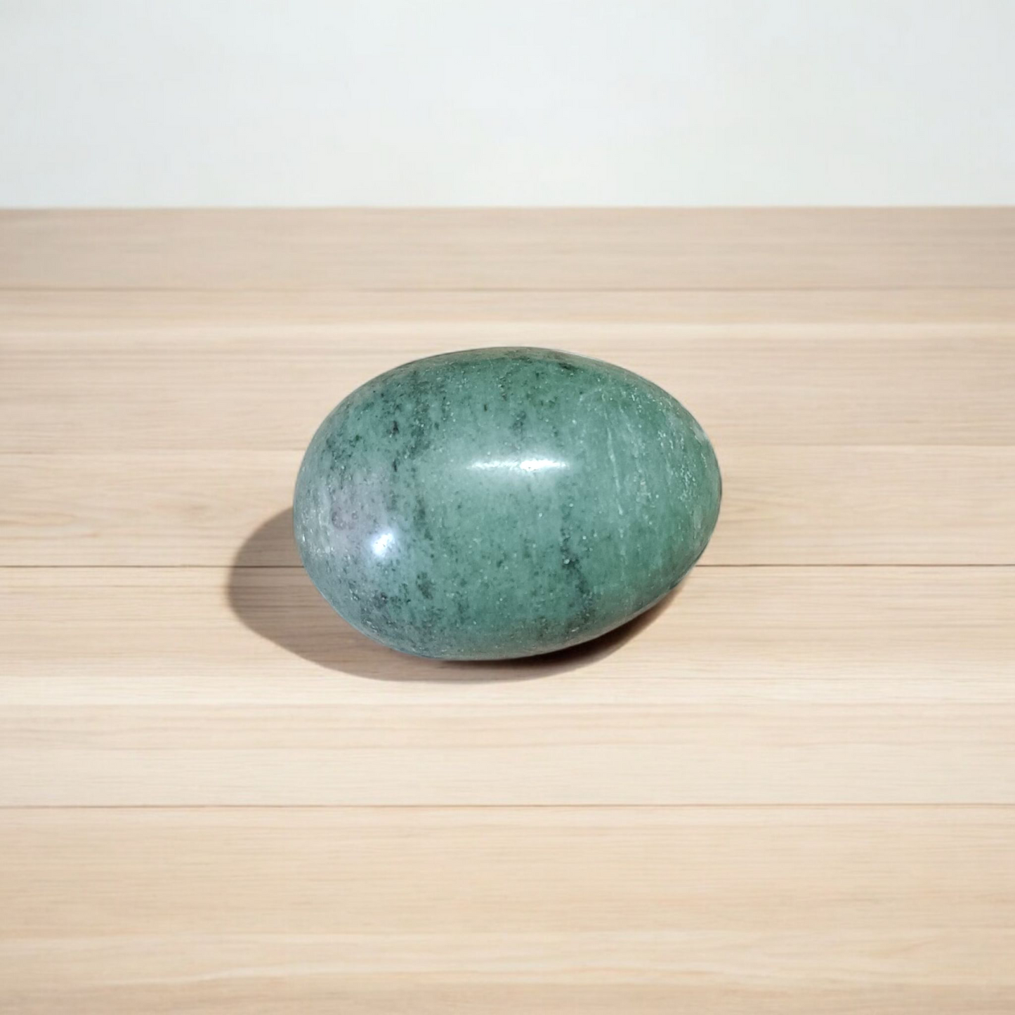 A natural greenish-black Shivling stone, hand-carved and polished, ideal for Tulsi plants, garden altars, and temple worship