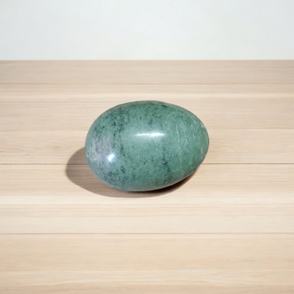 A natural greenish-black Shivling stone, hand-carved and polished, ideal for Tulsi plants, garden altars, and temple worship