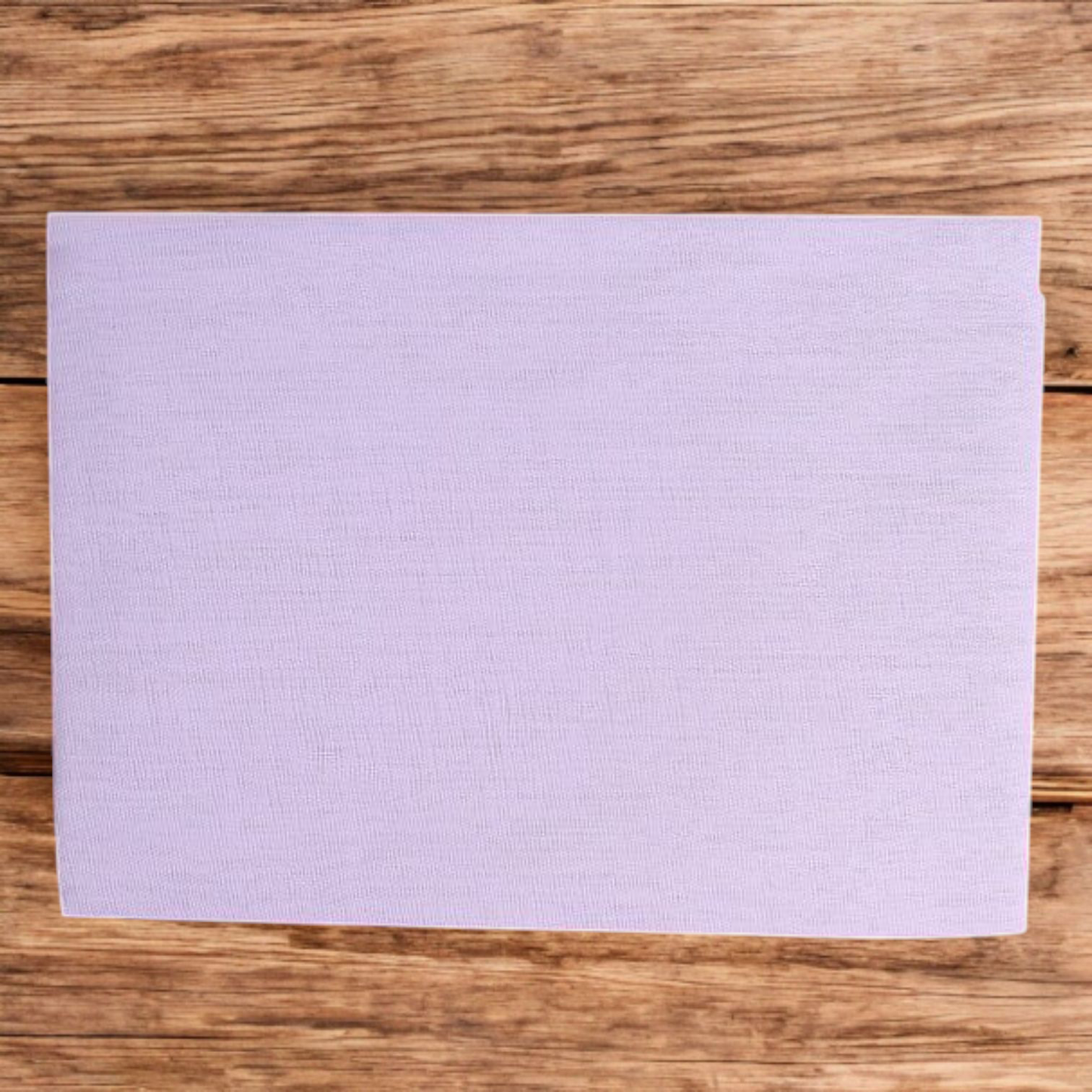 A neatly folded pure white cotton cloth used for Hindu rituals and poojas, displayed on a wooden surface