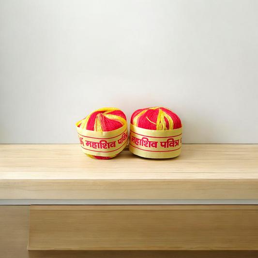 A pair of red and yellow sacred Moli Kalawa cotton threads neatly coiled, used in Hindu pooja rituals