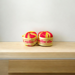 A pair of red and yellow sacred Moli Kalawa cotton threads neatly coiled, used in Hindu pooja rituals