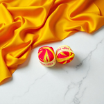 A pair of red and yellow sacred Moli Kalawa cotton threads neatly coiled, used in Hindu pooja rituals
