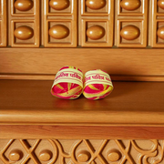 A pair of red and yellow sacred Moli Kalawa cotton threads neatly coiled, used in Hindu pooja rituals