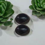 A polished black natural stone Shivling on a smooth base, used for spiritual worship, pooja, and rituals