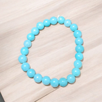 A polished natural blue chalcedony bracelet with 8mm round beads on an elastic stretchable cord, handcrafted for healing and style