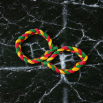 A set of two handmade Resham thread bracelets in vibrant colors, symbolizing good luck, positive energy, and success, displayed on a woman’s wrist