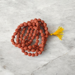 A spiritual combo featuring a 5 Mukhi Rudraksha Mala, a red velvet Pooja Aasan with golden border, and a traditional Gomukhi Japa Bag – all lab certified
