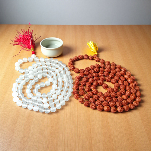 A spiritual combo of Sphatik Mala and Rudraksha Mala placed together, showing the clear quartz beads and brown Rudraksha seeds in detailed view