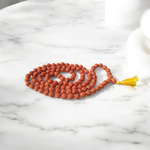 A spiritual combo of Sphatik Mala and Rudraksha Mala placed together, showing the clear quartz beads and brown Rudraksha seeds in detailed view