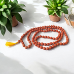 A spiritual combo of Sphatik Mala and Rudraksha Mala placed together, showing the clear quartz beads and brown Rudraksha seeds in detailed view