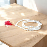 A spiritual combo of Sphatik Mala and Rudraksha Mala placed together, showing the clear quartz beads and brown Rudraksha seeds in detailed view