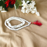 A spiritual combo of Sphatik Mala and Rudraksha Mala placed together, showing the clear quartz beads and brown Rudraksha seeds in detailed view