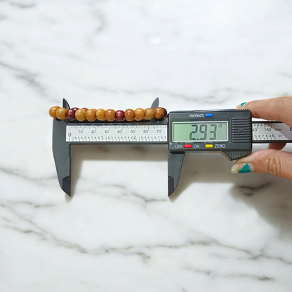A stretchable bracelet made of alternating white and red 8mm sandalwood beads, displayed on a neutral background
