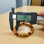 A stretchable bracelet made of alternating white and red 8mm sandalwood beads, displayed on a neutral background
