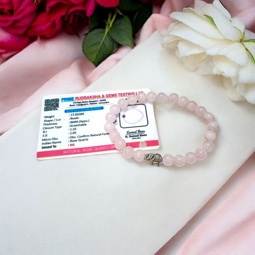 A stretchable natural rose quartz bracelet with 8mm round pink beads, displayed on a white background