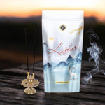 A zipper pouch of Kasturi-scented Agarbatti sticks with sleek black packaging and natural incense sticks beside it