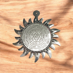 Ashtbhairav Yantra with gold finish and black thread for hanging, displayed against a white background