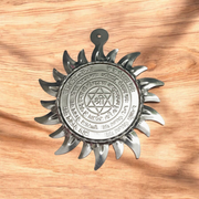 Ashtbhairav Yantra with gold finish and black thread for hanging, displayed against a white background