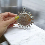 Ashtbhairav Yantra with gold finish and black thread for hanging, displayed against a white background