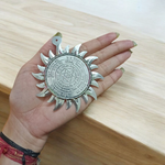 Ashtbhairav Yantra with gold finish and black thread for hanging, displayed against a white background