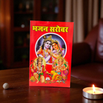 Bhajan Book in Hindi featuring devotional artwork and placed alongside diya and incense in a traditional prayer setting