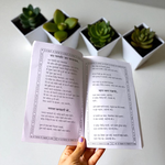 Bhajan Ganga Hindi Book with colorful spiritual design, placed on a wooden prayer stand with diya and flowers