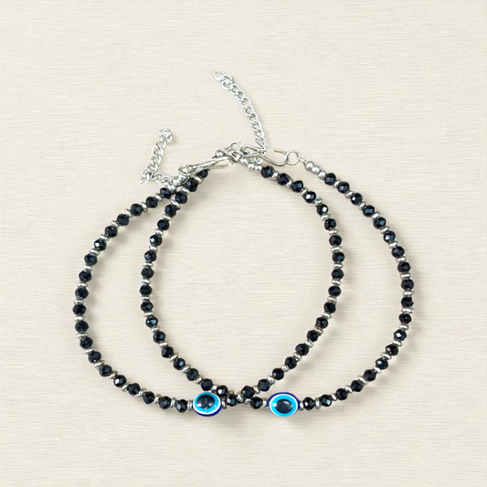 Black bead anklet for women with central evil eye charm, adjustable design for daily wear and spiritual protection by MALAWALA