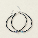 Black bead anklet for women with central evil eye charm, adjustable design for daily wear and spiritual protection by MALAWALA
