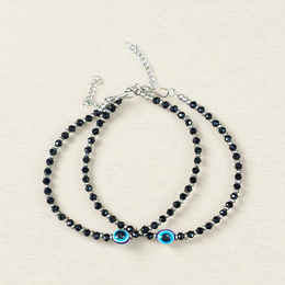 Black bead anklet for women with central evil eye charm, adjustable design for daily wear and spiritual protection by MALAWALA