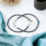 Black bead anklet for women with central evil eye charm, adjustable design for daily wear and spiritual protection by MALAWALA