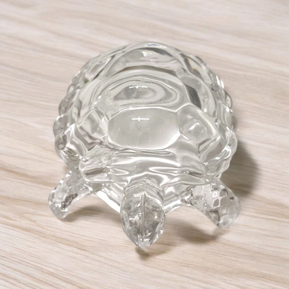 Clear crystal tortoise on round crystal plate, symbolizing Feng Shui stability and prosperity
