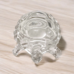 Clear crystal tortoise on round crystal plate, symbolizing Feng Shui stability and prosperity