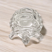 Clear crystal tortoise on round crystal plate, symbolizing Feng Shui stability and prosperity