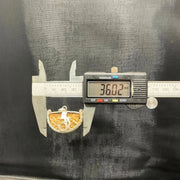 Close-up image of 1 Mukhi Rudraksha - One Face Kaju Rudraksha pendant with a lab certificate, highlighting its natural texture and shape.