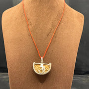 Close-up image of 1 Mukhi Rudraksha - One Face Kaju Rudraksha pendant with a lab certificate, highlighting its natural texture and shape.