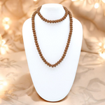Close-up image of 7 Mukhi Rudraksha Mala 8MM beads showing natural texture and polished finish