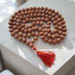 Close-up image of 7 Mukhi Rudraksha Mala 8MM beads showing natural texture and polished finish