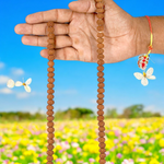 Close-up image of 7 Mukhi Rudraksha Mala 8MM beads showing natural texture and polished finish