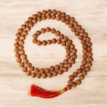 Close-up image of 7 Mukhi Rudraksha Mala 8MM beads showing natural texture and polished finish