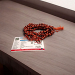 Close-up image of Lal Chandan Mala with natural red sandalwood beads in 108+1 and 27+1 variants, placed on a spiritual altar setting