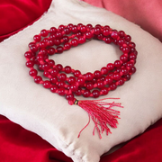 Close-up image of Natural Red Agate Mala with 108+1 polished red beads, used for Jaap and daily wear, handcrafted and lab-certified