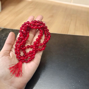 Close-up image of Natural Red Agate Mala with 108+1 polished red beads, used for Jaap and daily wear, handcrafted and lab-certified