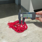 Close-up image of Natural Red Agate Mala with 108+1 polished red beads, used for Jaap and daily wear, handcrafted and lab-certified