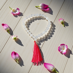 Close-up image of a premium 108+1 bead Sphatik (Crystal) Mala with 8MM beads, hand-knotted, radiant clear quartz beads, laid out on a white background